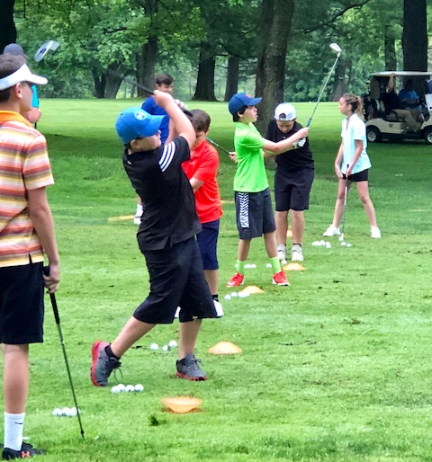 Junior golfers practicing their golf swings