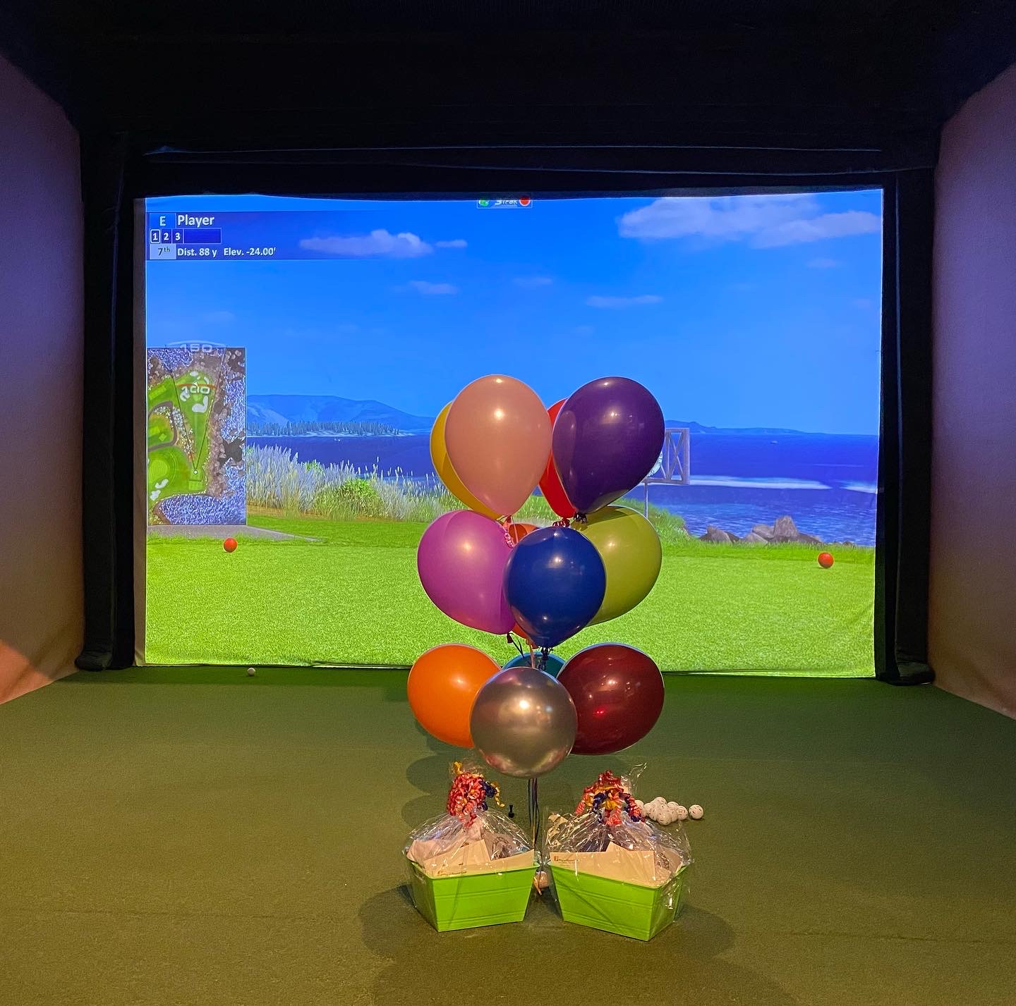 Party Balloons in front of a Play-a-Round Golf golf simulator